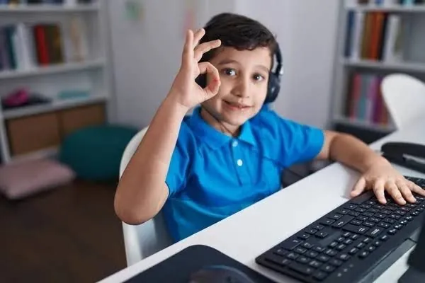 A smiling student using a computer